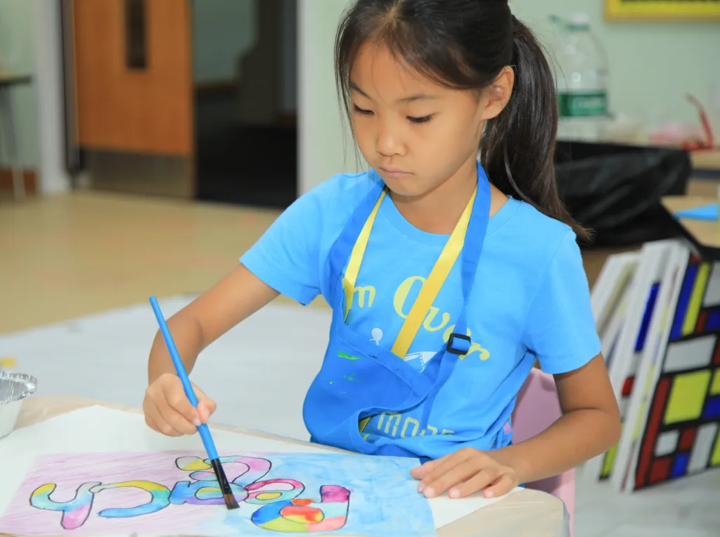 Student painting a colorful project