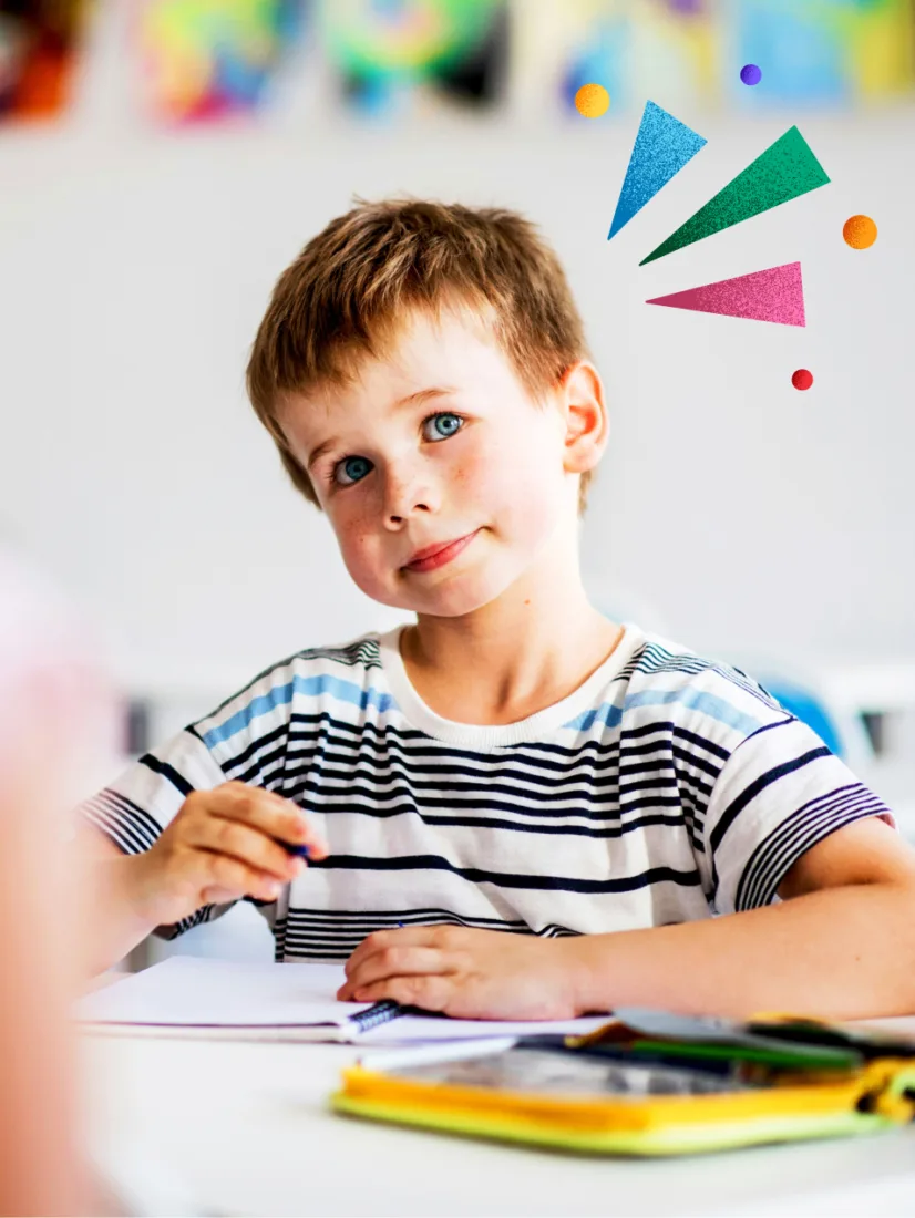 A young student drawing at a desk